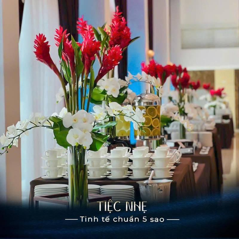 Bàn tiệc được trang trí hoa và bộ ấm chén chuẩn bị cho tổ chức đại hội cổ đông chuyên nghiệp trọn gói HCM.